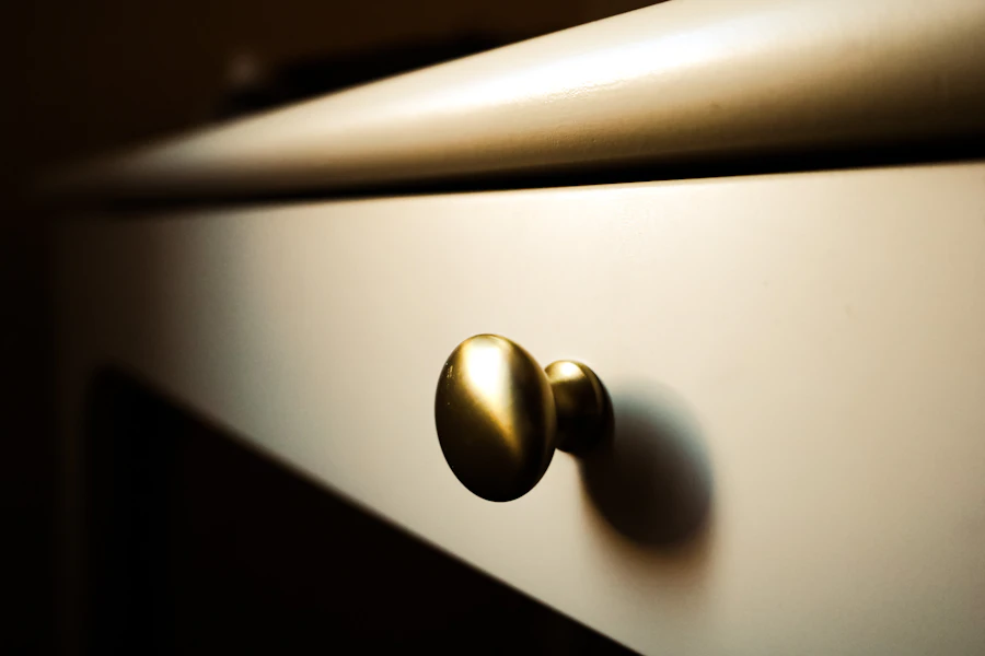 Brass knob on a cream cabinet drawer